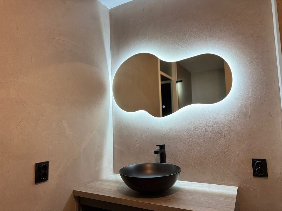 Badkamer met beton ciré en organische verlichte spiegel